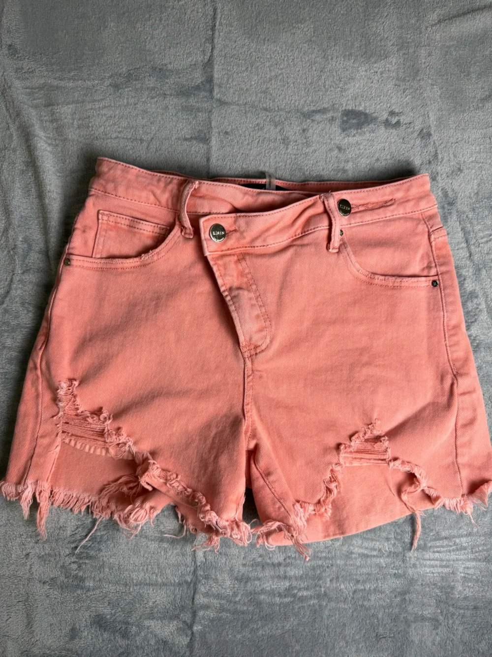 Risen Women’s High Rise Distressed Asymmetrical Coral Jean Shorts- Medium